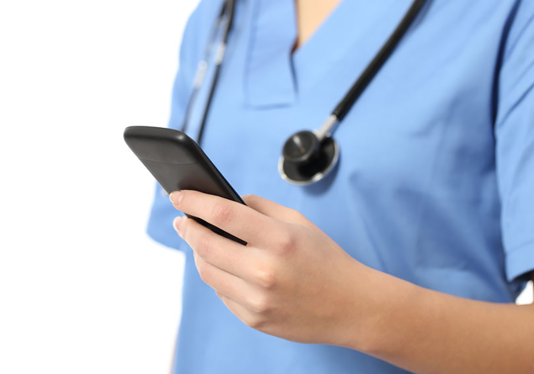 Nurse using a mobile phone to register online.
