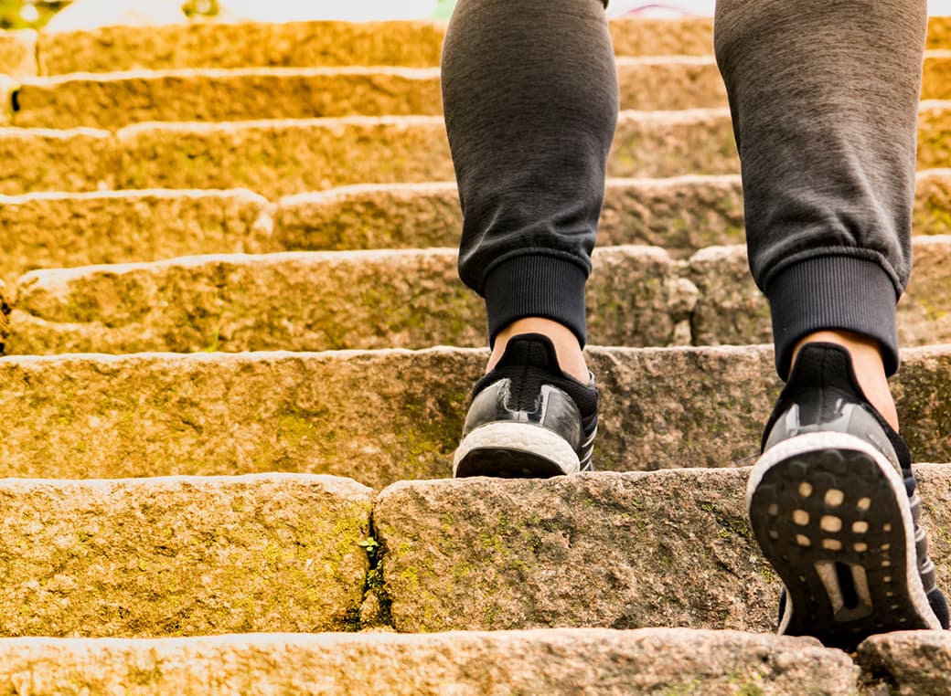 A man climbing stone steps.