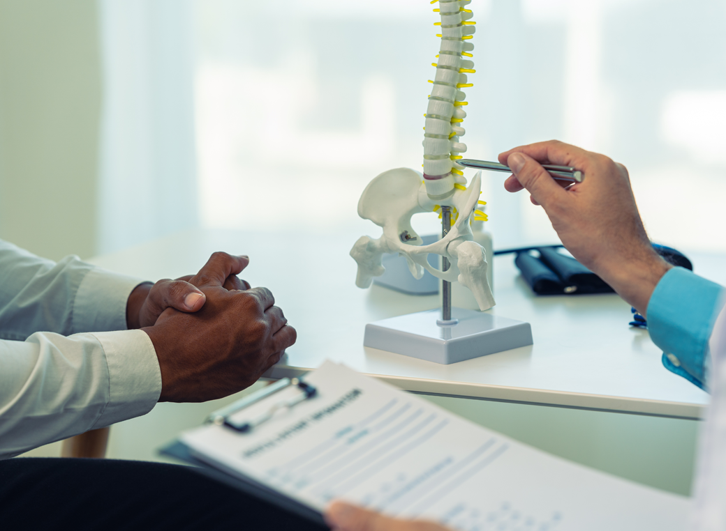 Physician explaining chiropractic issues to patient