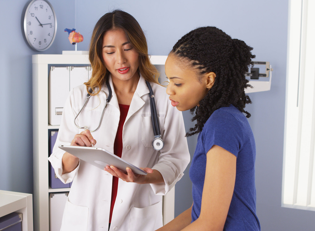 Patient explaining issues to doctor using tablet