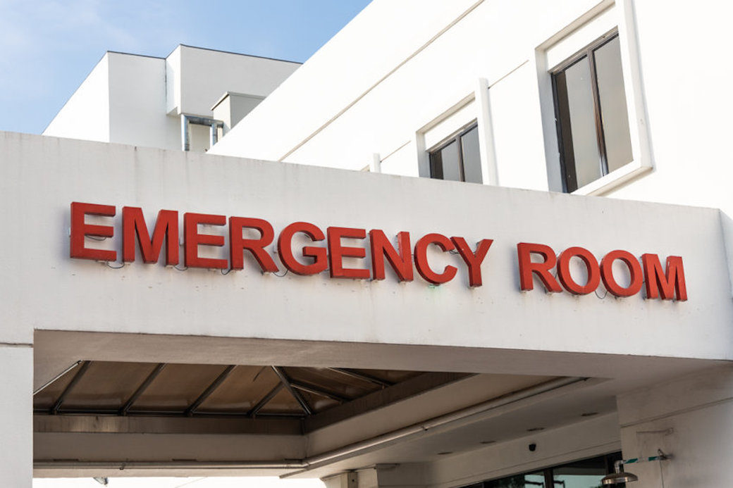 Closeup of emergency entrance signage in hospital room with medical symbols.