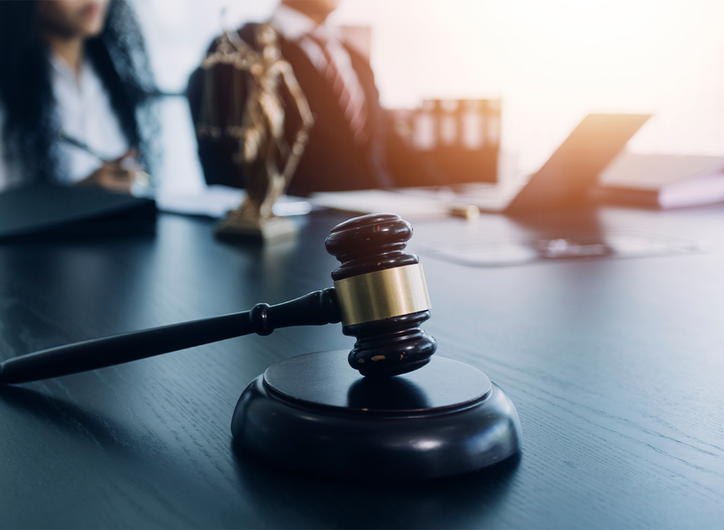 lawyer working with computer and gavel on table in office.