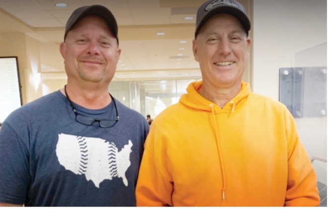 Two UPS co-workers smiling after they saved a life with a kidney transplant.