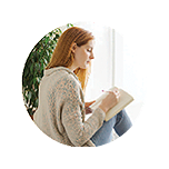 A women writing in a notebook.