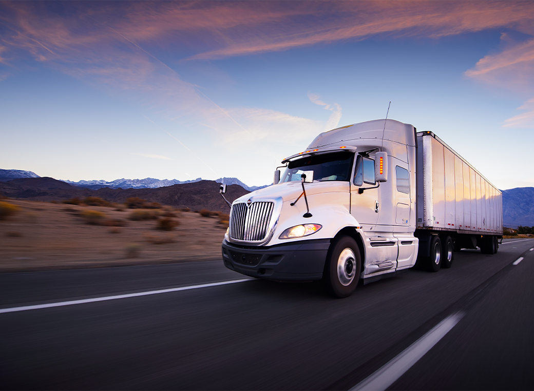 Truck and highway at sunset - transportation background